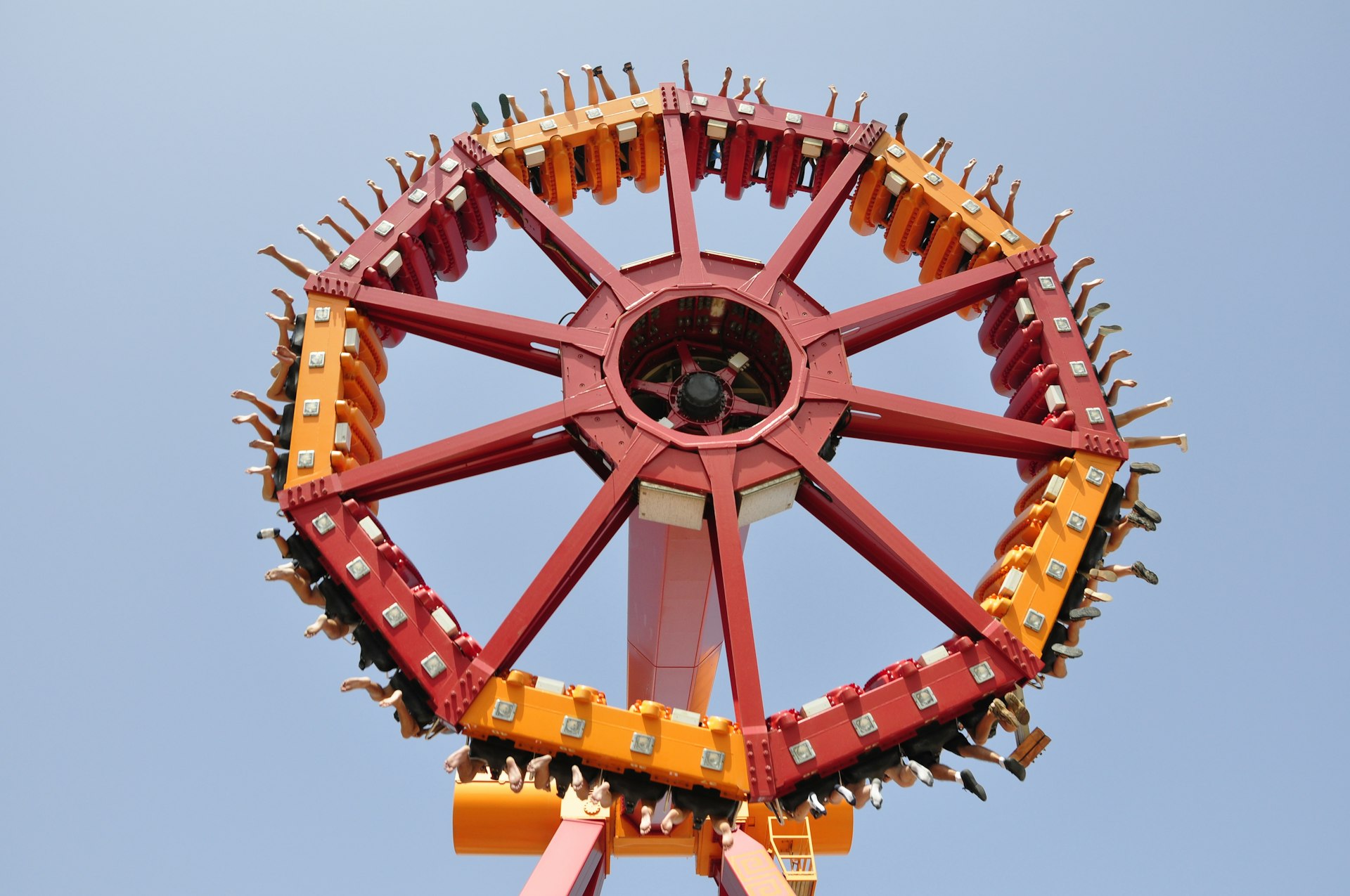 Parkgoers feet hanging from a circular ride in the air at Terra Mitica amusement park in Benidorm, Spain