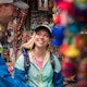 Young caucasian man and woman shopping for souvenirs in a local market in Cusco, Peru.
