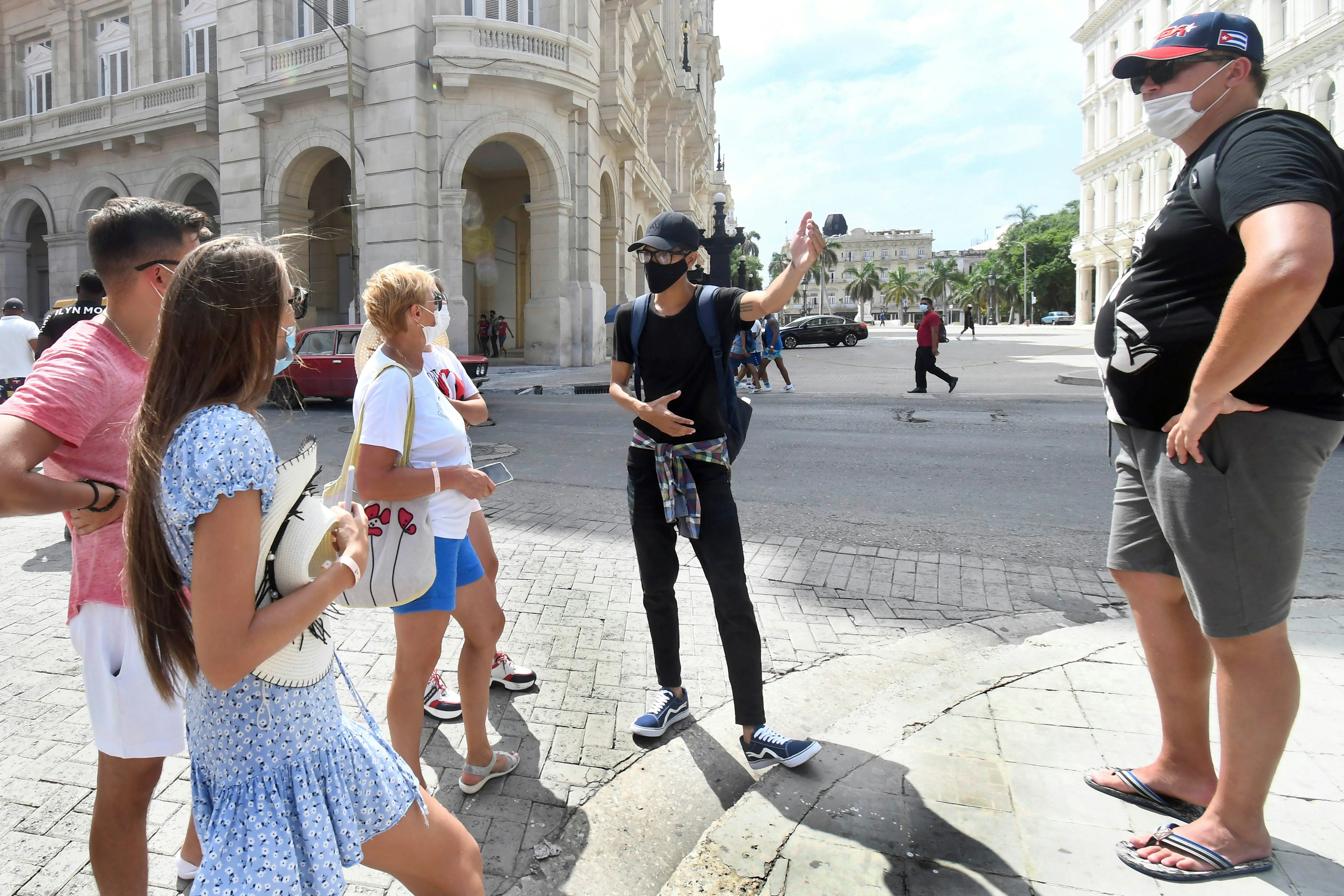 Tourists have chat on a street amid the COVID-19 pandemic in Havana, Cuba, Oct. 2, 2021