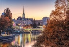 View of Vienna, evening city lights reflecting in Danube canal and temple of St. Stephen's Cathedral from Leopoldstadt district late autumn sunset