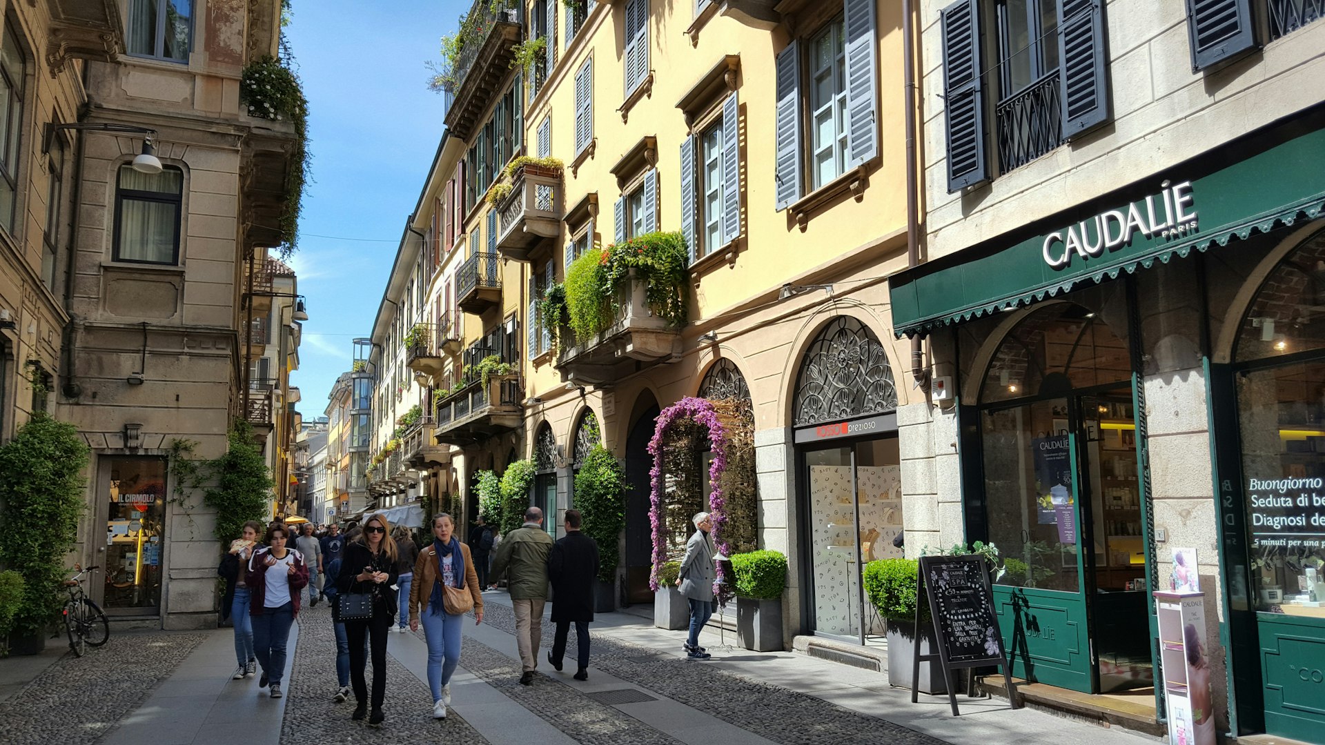 Old-fashioned cobbled street with shops and cafes in the Brera district in Milan, Italy