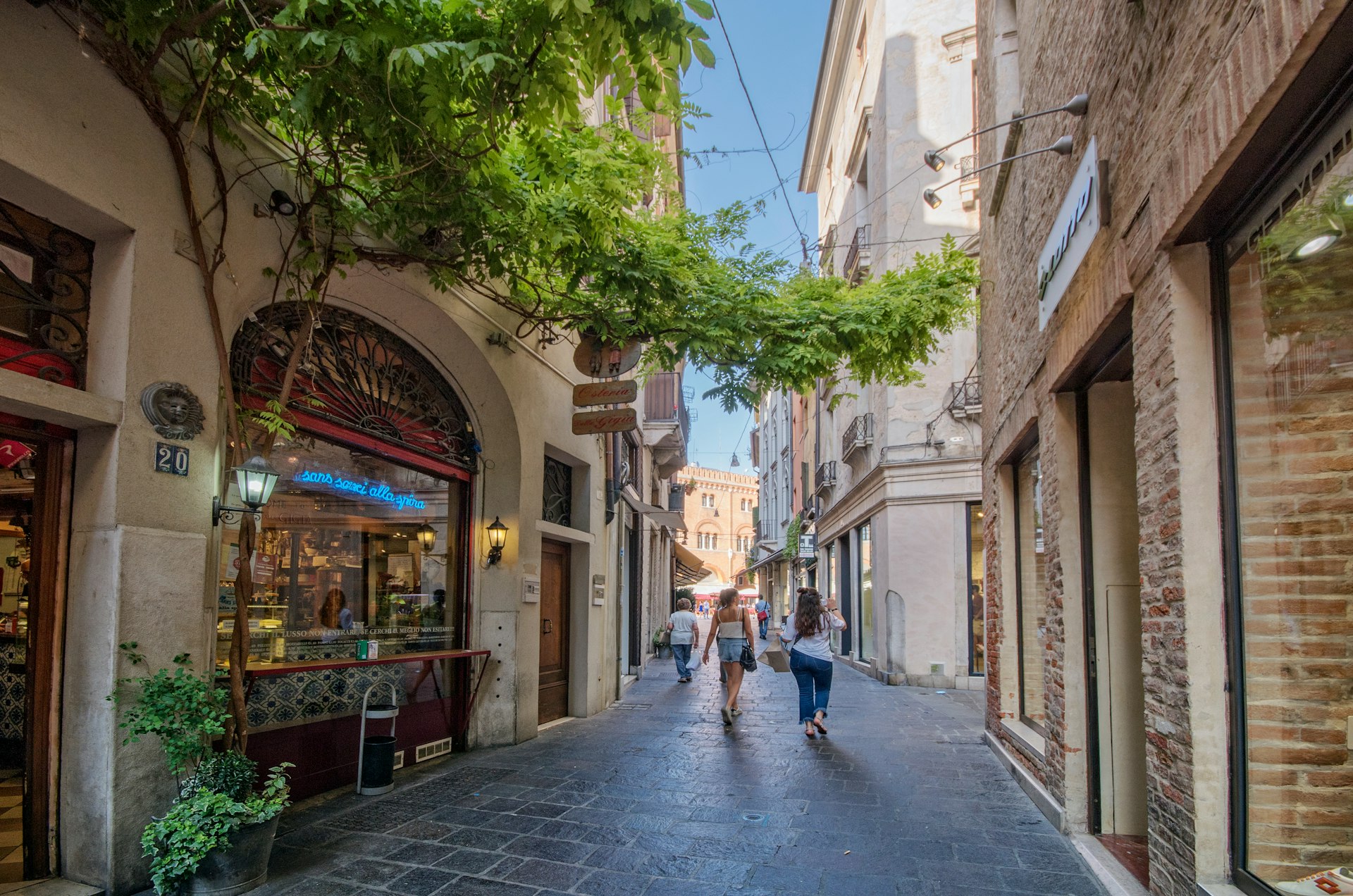 Pedestrians walk along Barberia street, near Signori Square, in Treviso 
