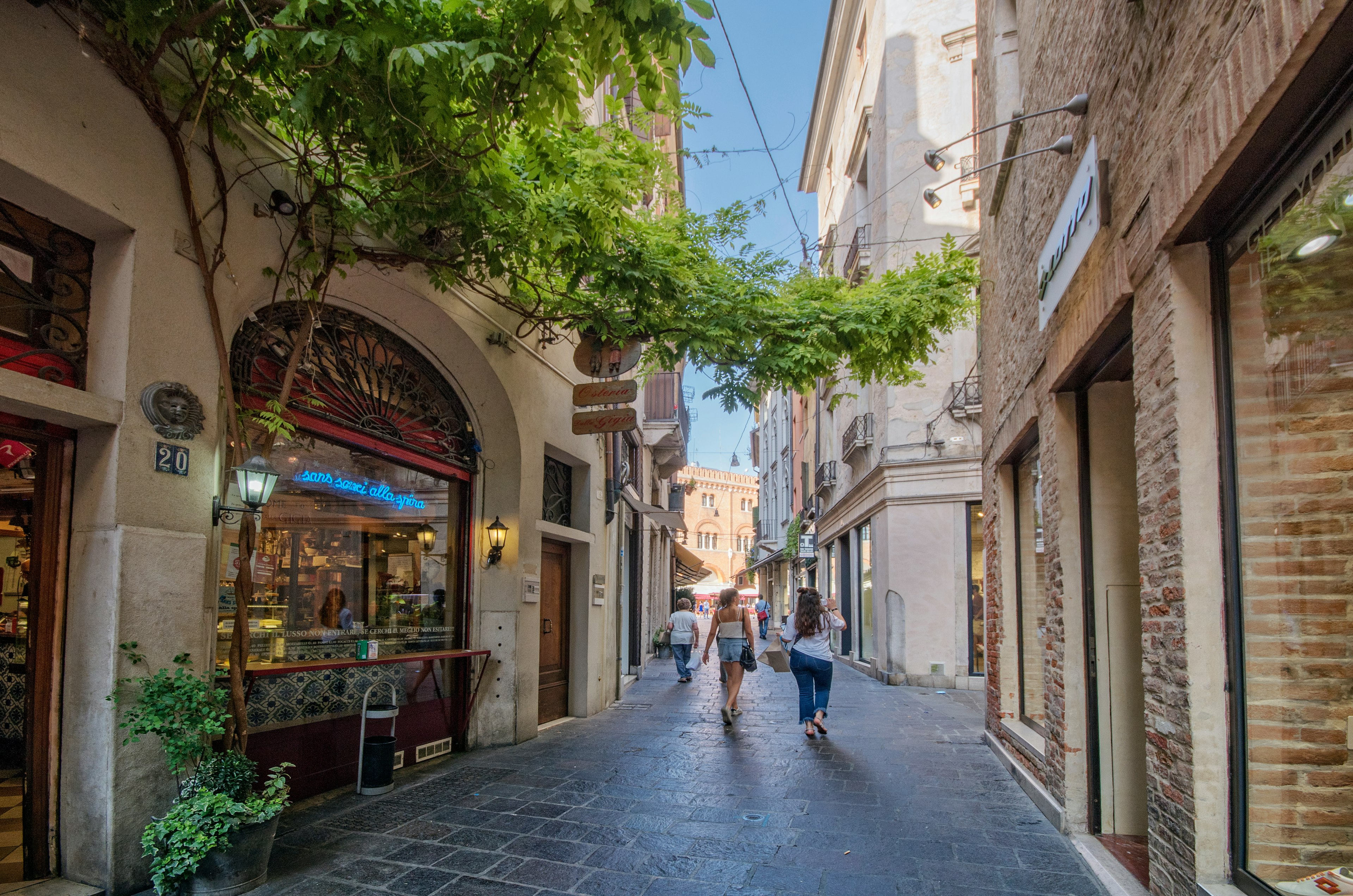 Pedestrians walk along Barberia street, near Signori Square, in Treviso