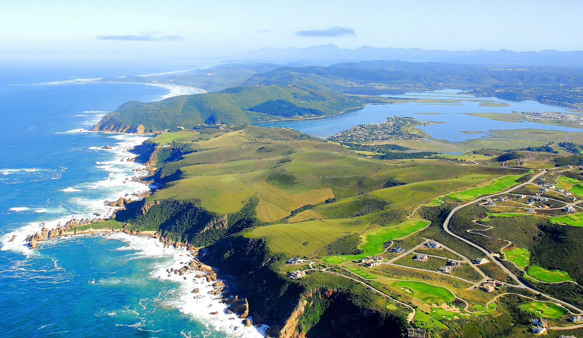 Aerial view of lush green fields and coastline in Knysna on the Garden Route, South Africa