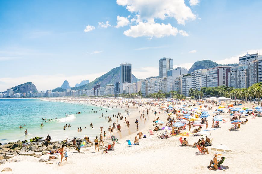 The crowded summer shoreline of Copacabana Beach in Rio de Janeiro