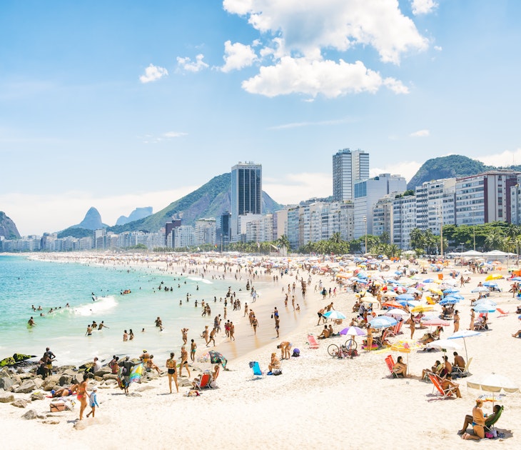 The crowded summer shoreline of Copacabana Beach in Rio de Janeiro.