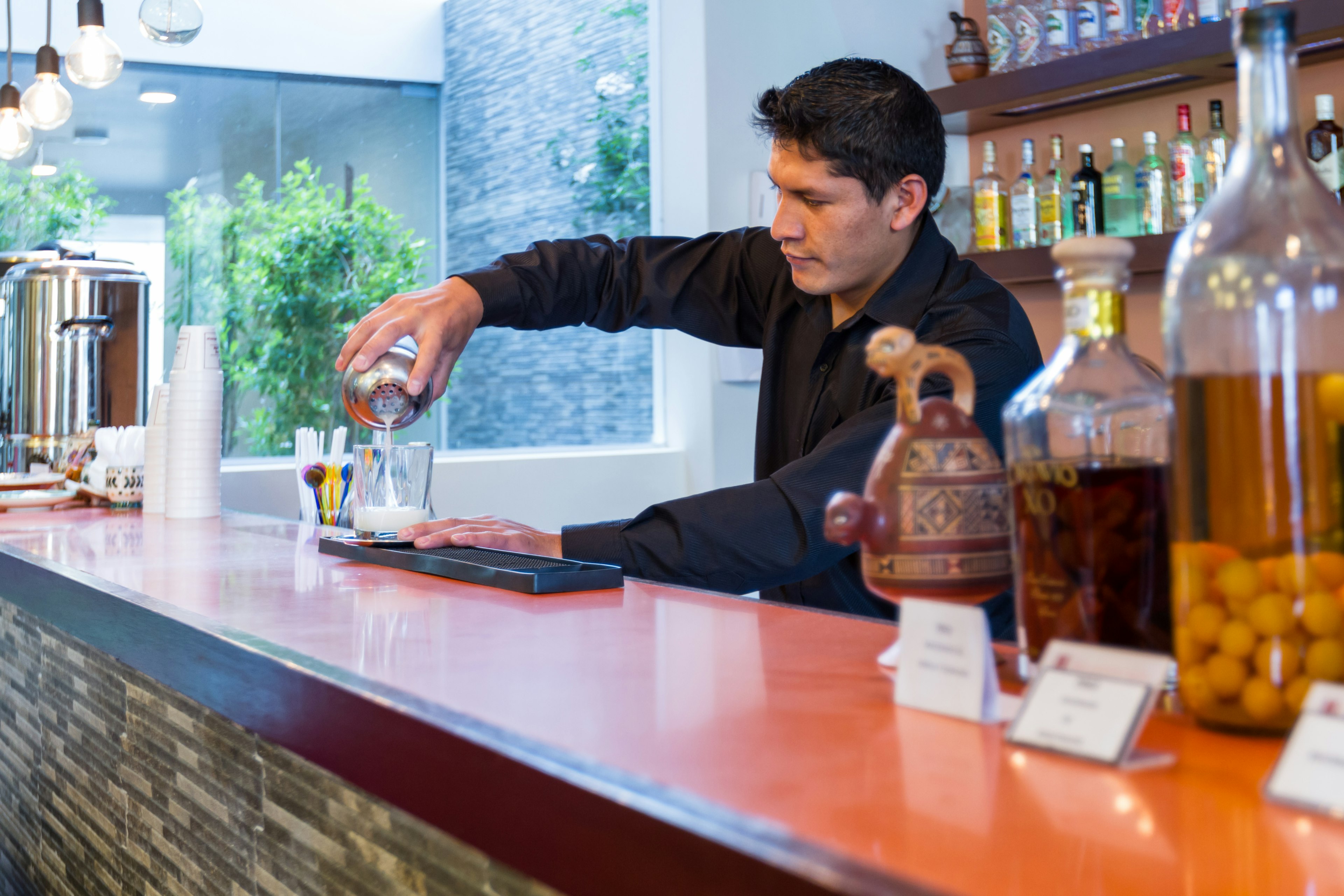 Bartender preparing a Pisco Sour