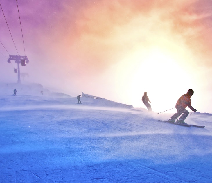 Skiers on the windy track under ski lift - colorful vivid sport picture