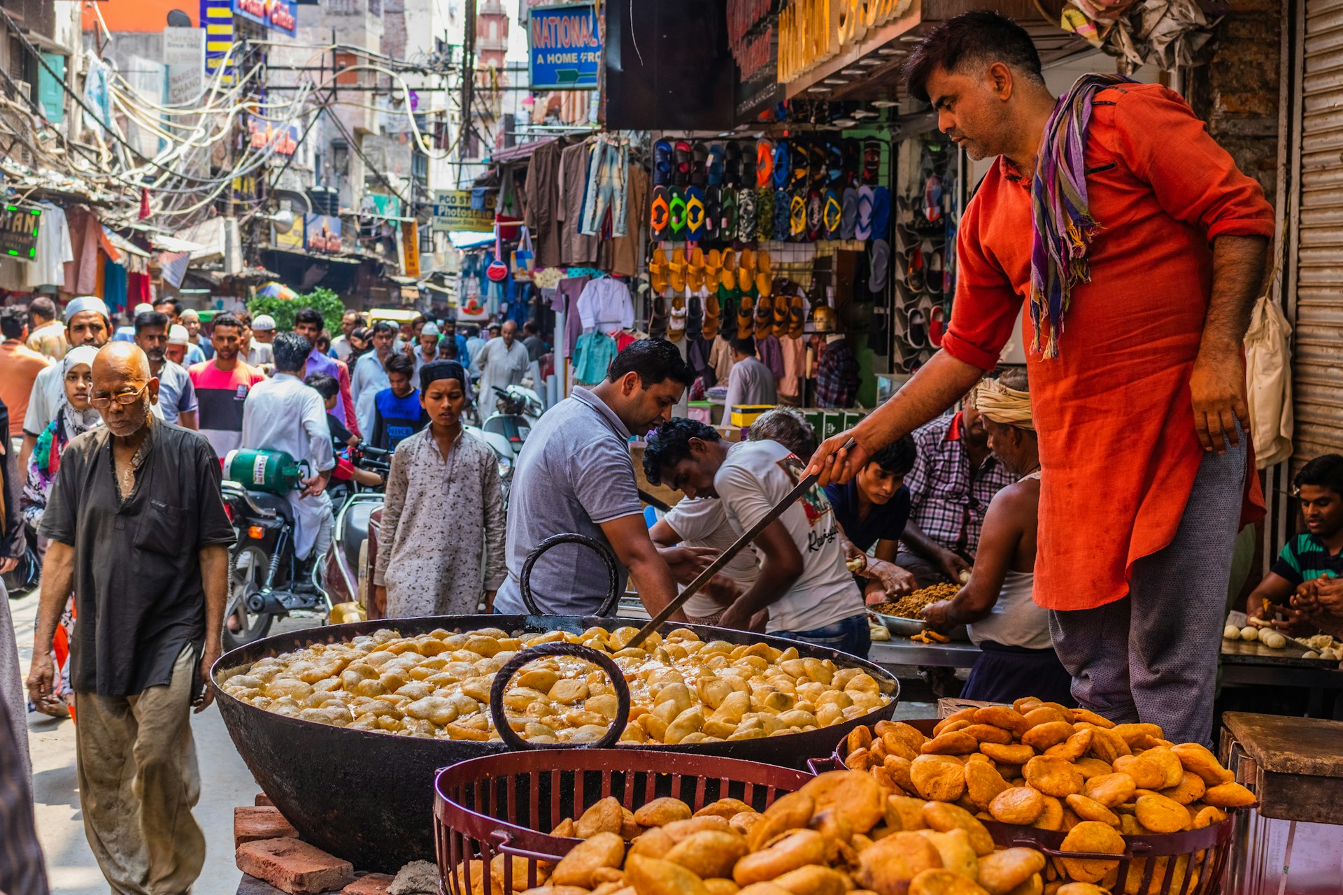 A New Delhi street scene, a man cooking