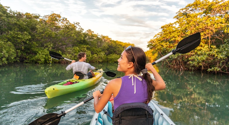 Couple kayaking together in mangrove river on Islamorada, Florida Keys