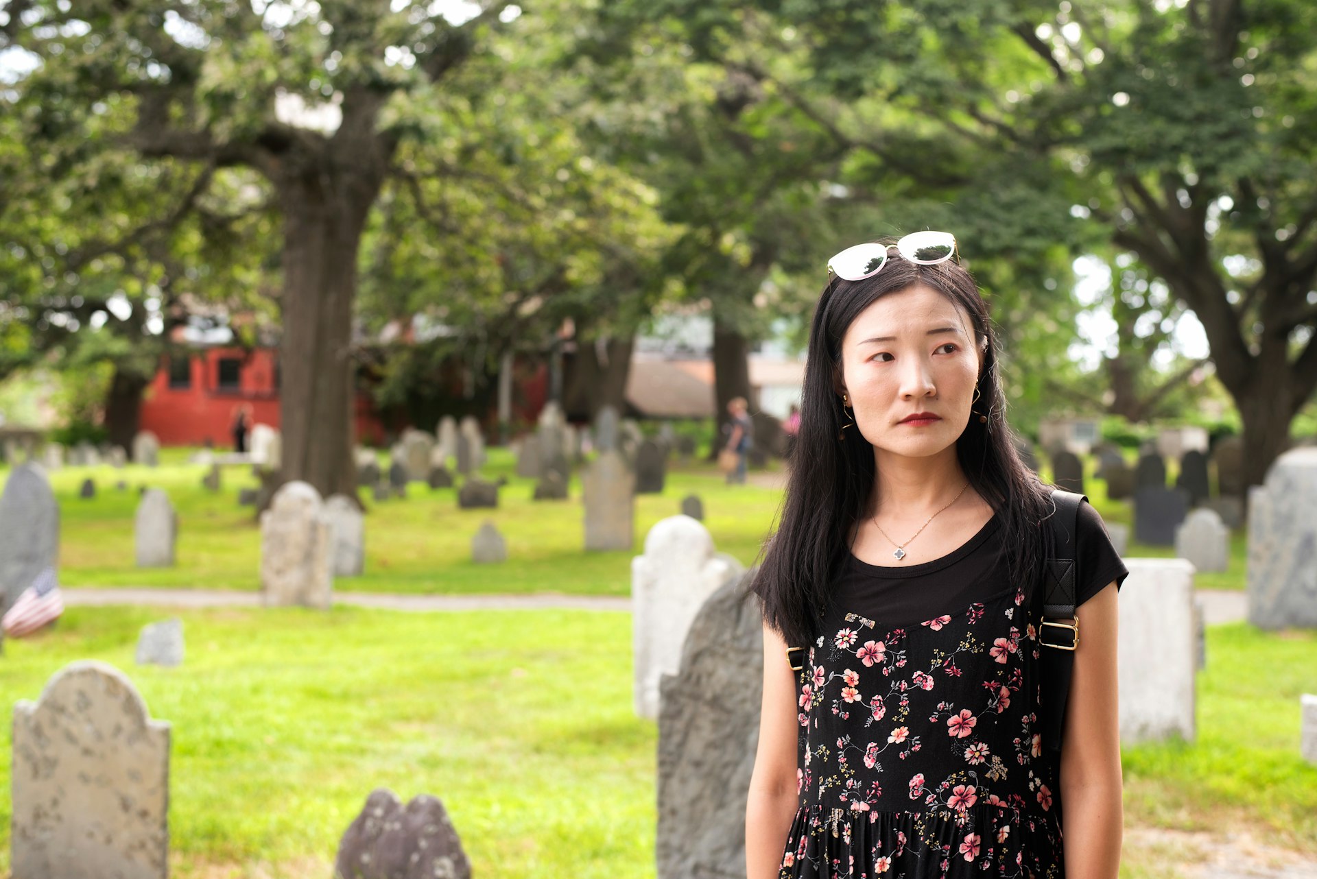 An Asian woman looking sombre in the Burying Point cemetery in Salem 