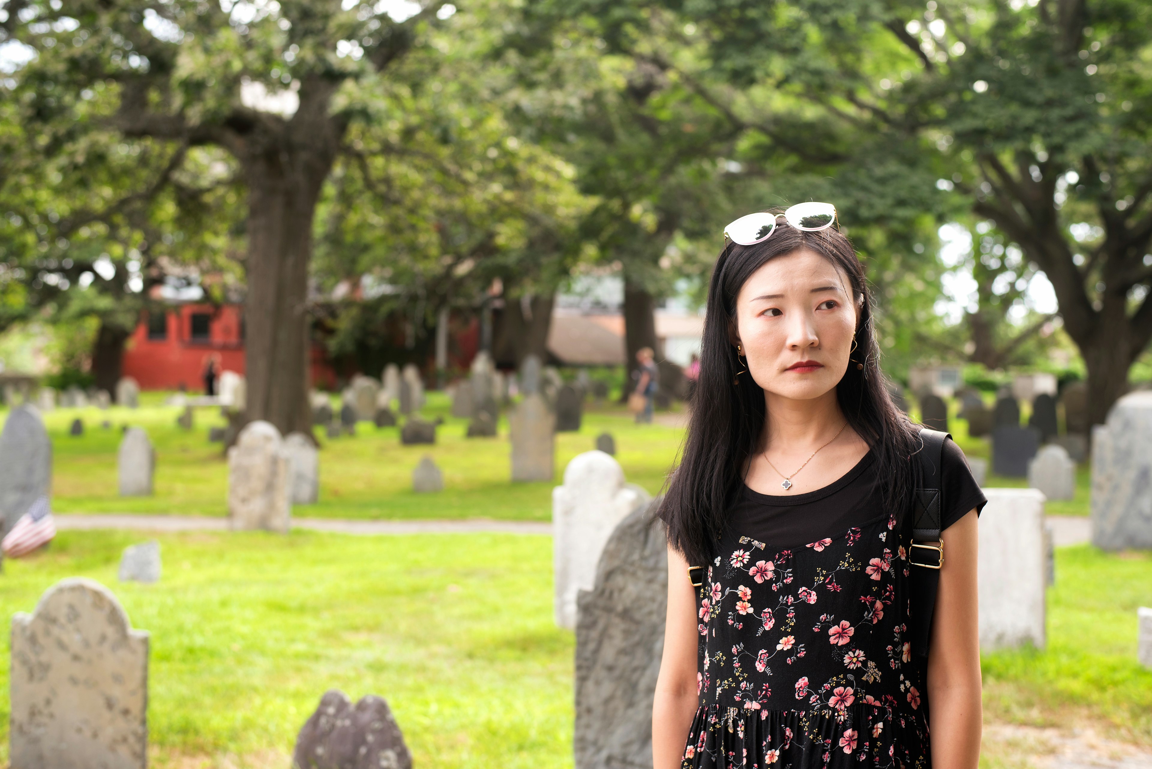 An Asian woman looking sombre in the Burying Point cemetery in Salem