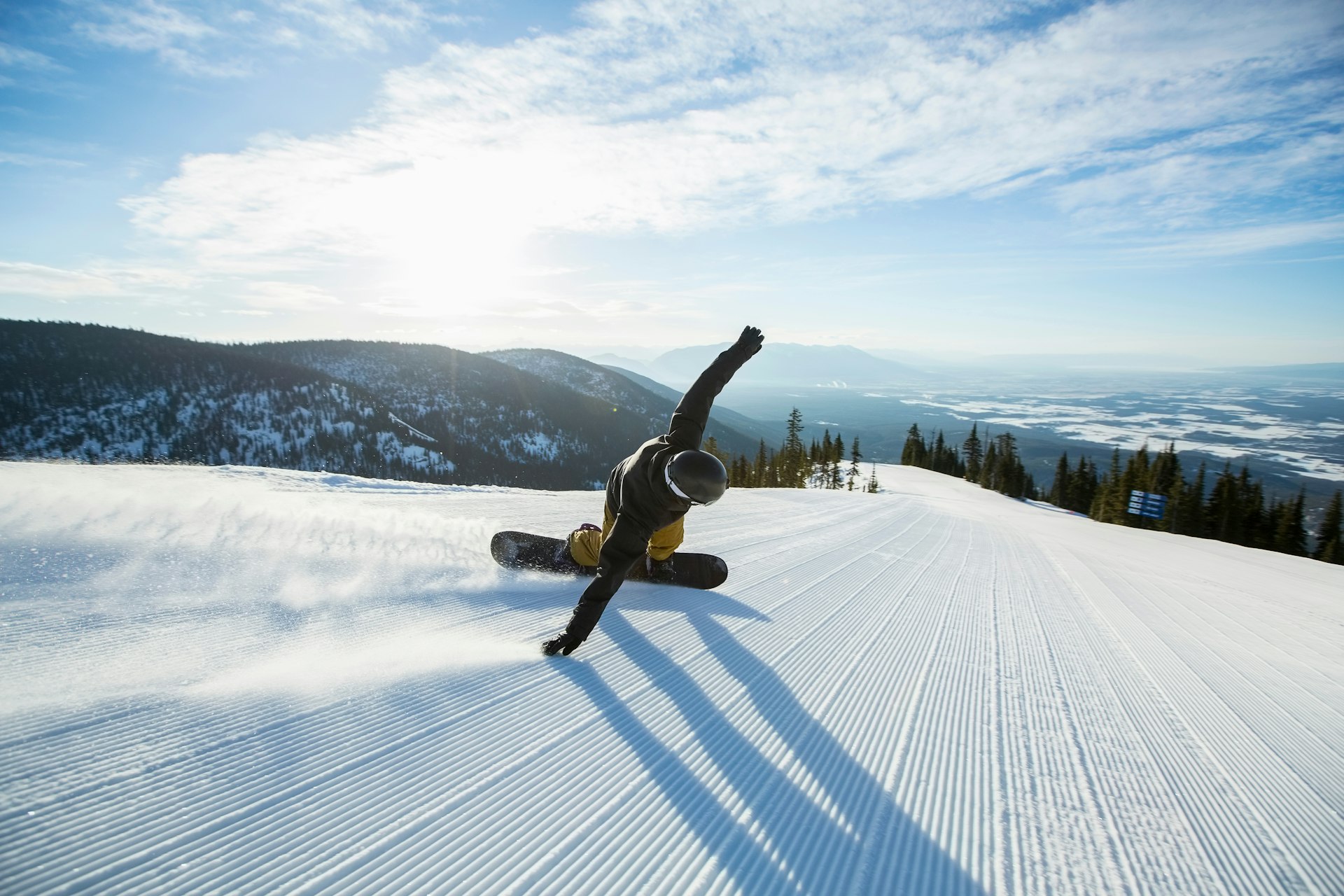 A snowboarder riding on a slope in Montana