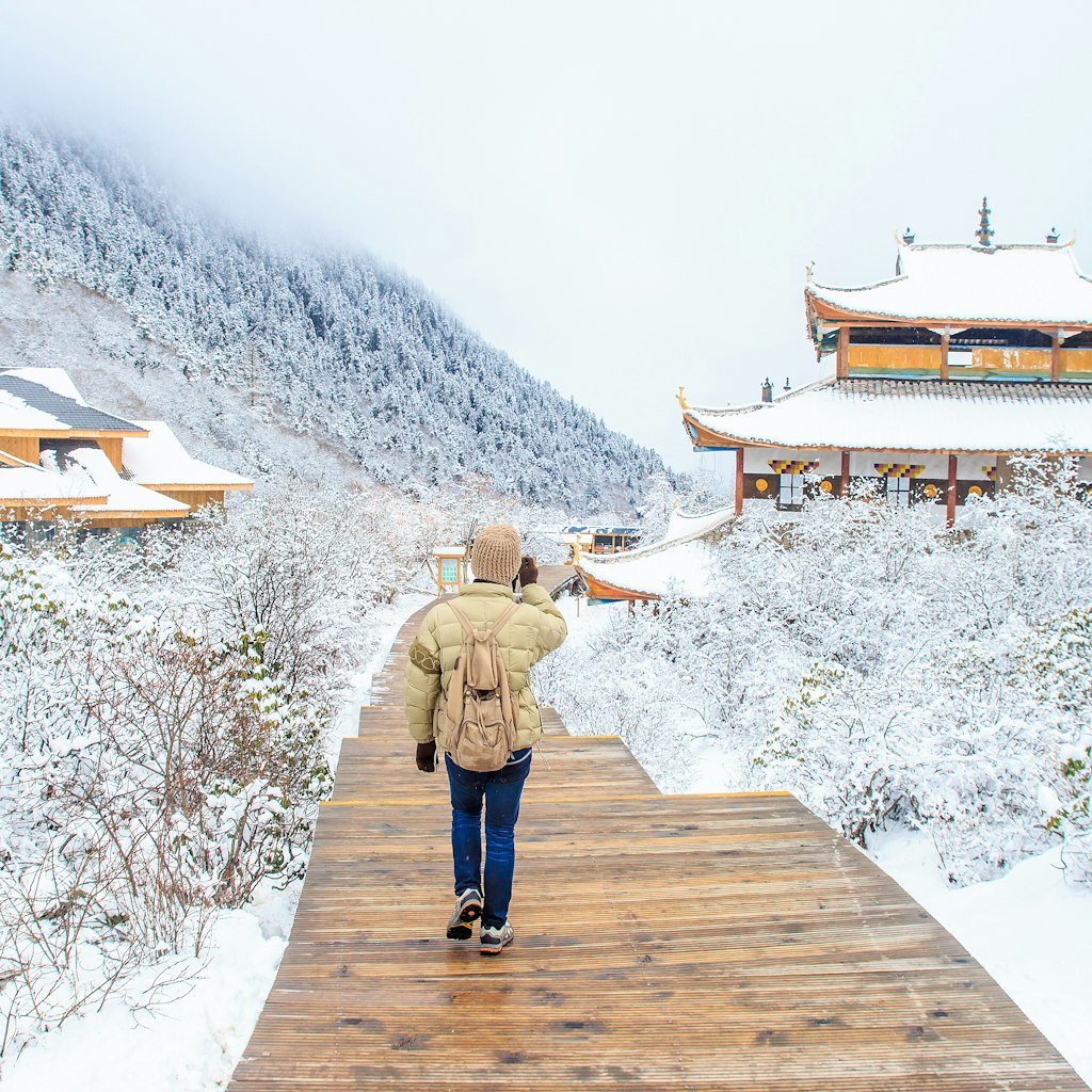 Traveler walking on the snow in Sichuan, China