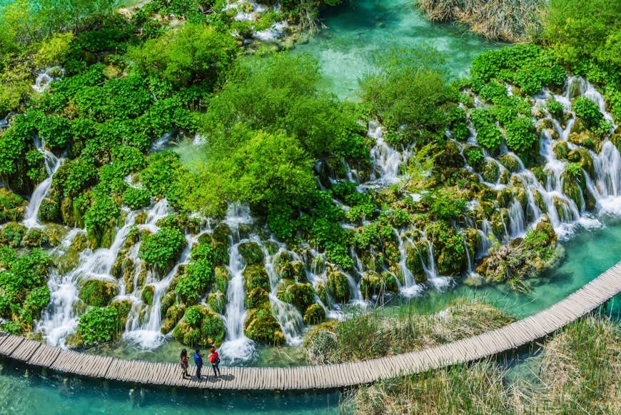 A boardwalk leads past a lake at Plitvice Lakes National Park in Croatia