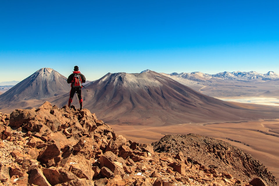 A trekker looking towards Licancabur volcano near San Pedro de Atacama, Chile