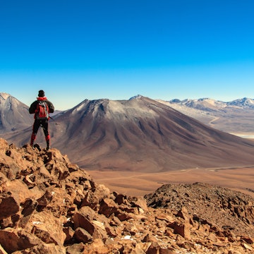 A trekker looking towards Licancabur volcano near San Pedro de Atacama, Chile