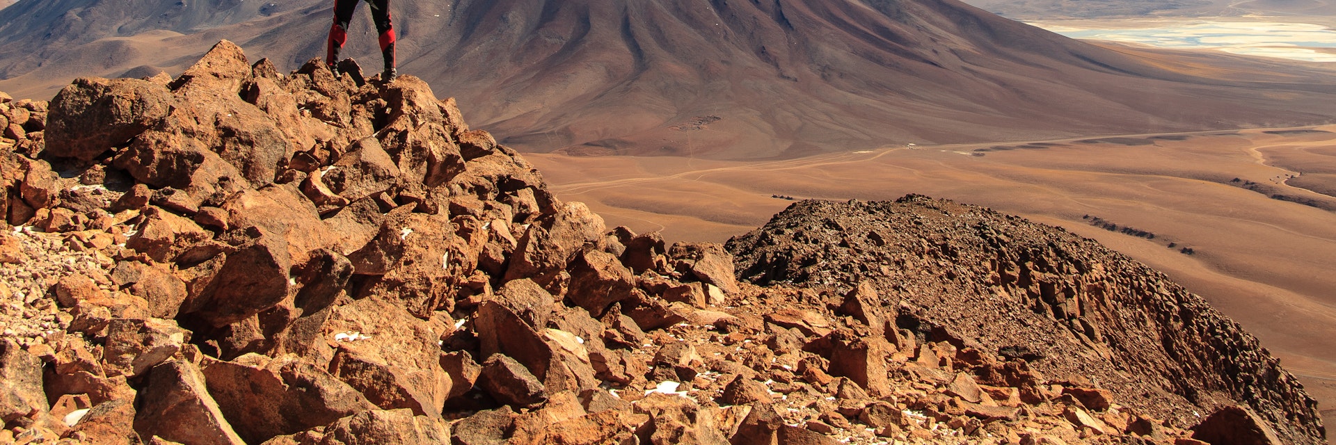 A trekker looking towards Licancabur volcano near San Pedro de Atacama, Chile