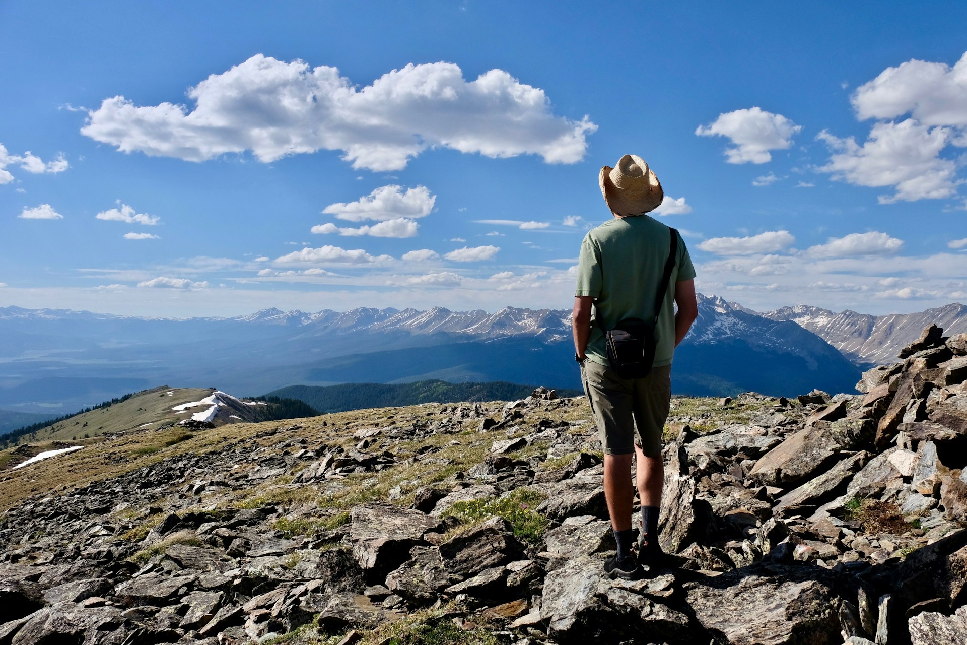 A man in a cowboy hat pausing to admire the views above Aspen, Colorado