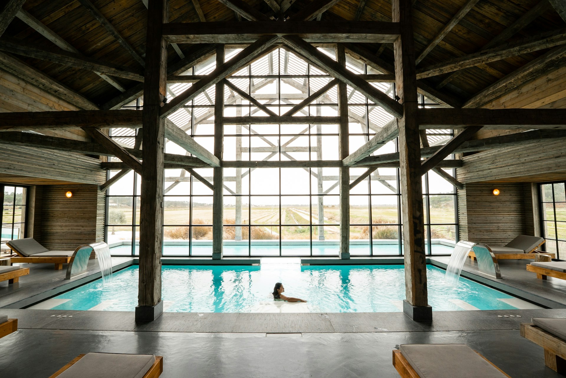 A guest relaxes in a beautiful hotel pool. 