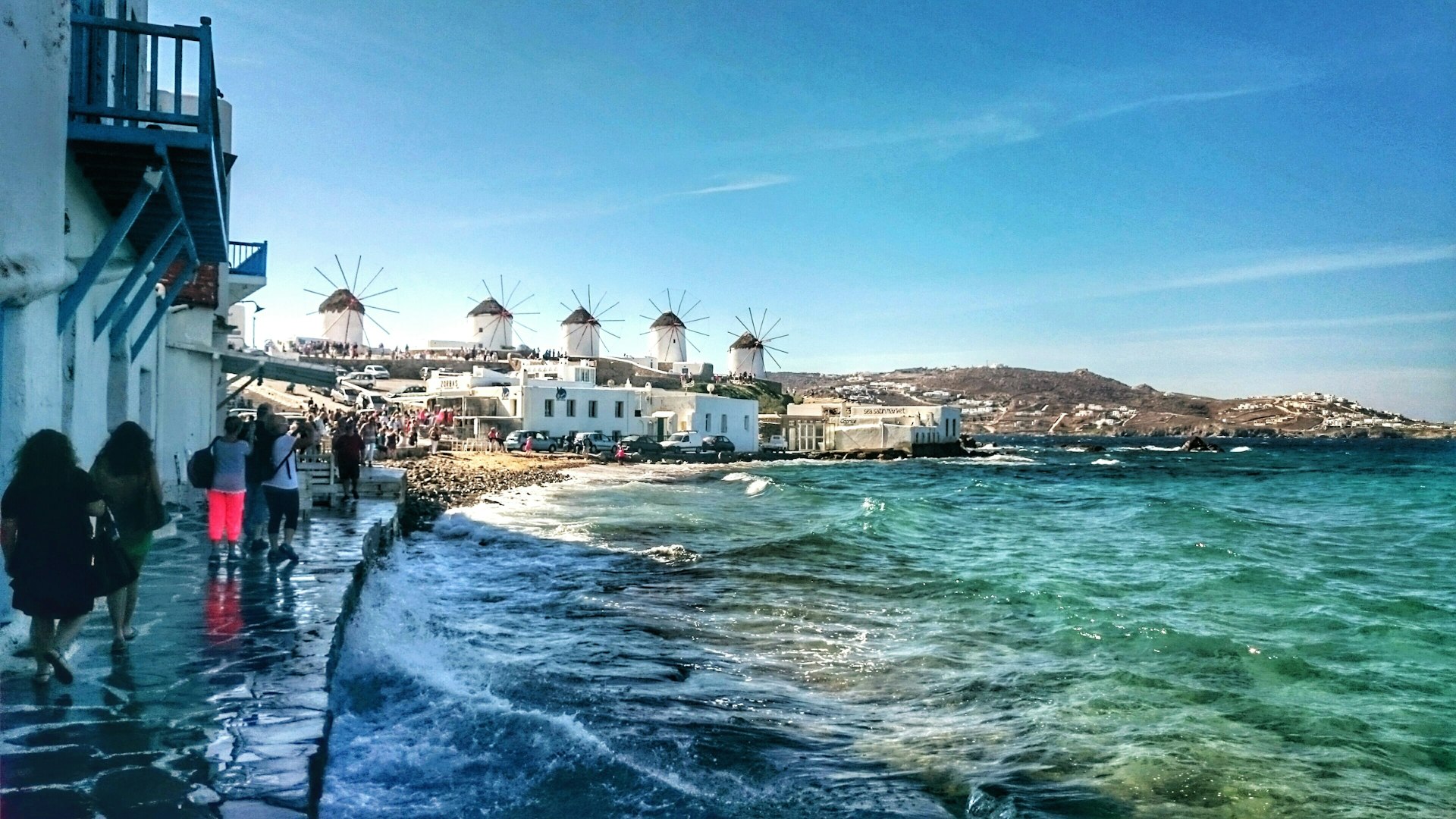 A scenic view of the windmills on Mykonos against a blue sky