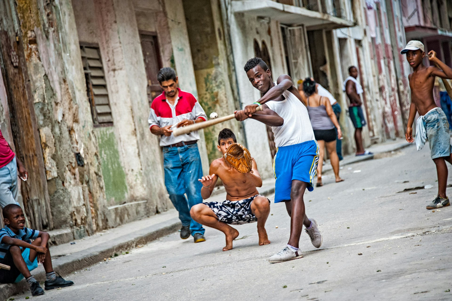 A group of kids play baseball in an alley of Havana, Cuba