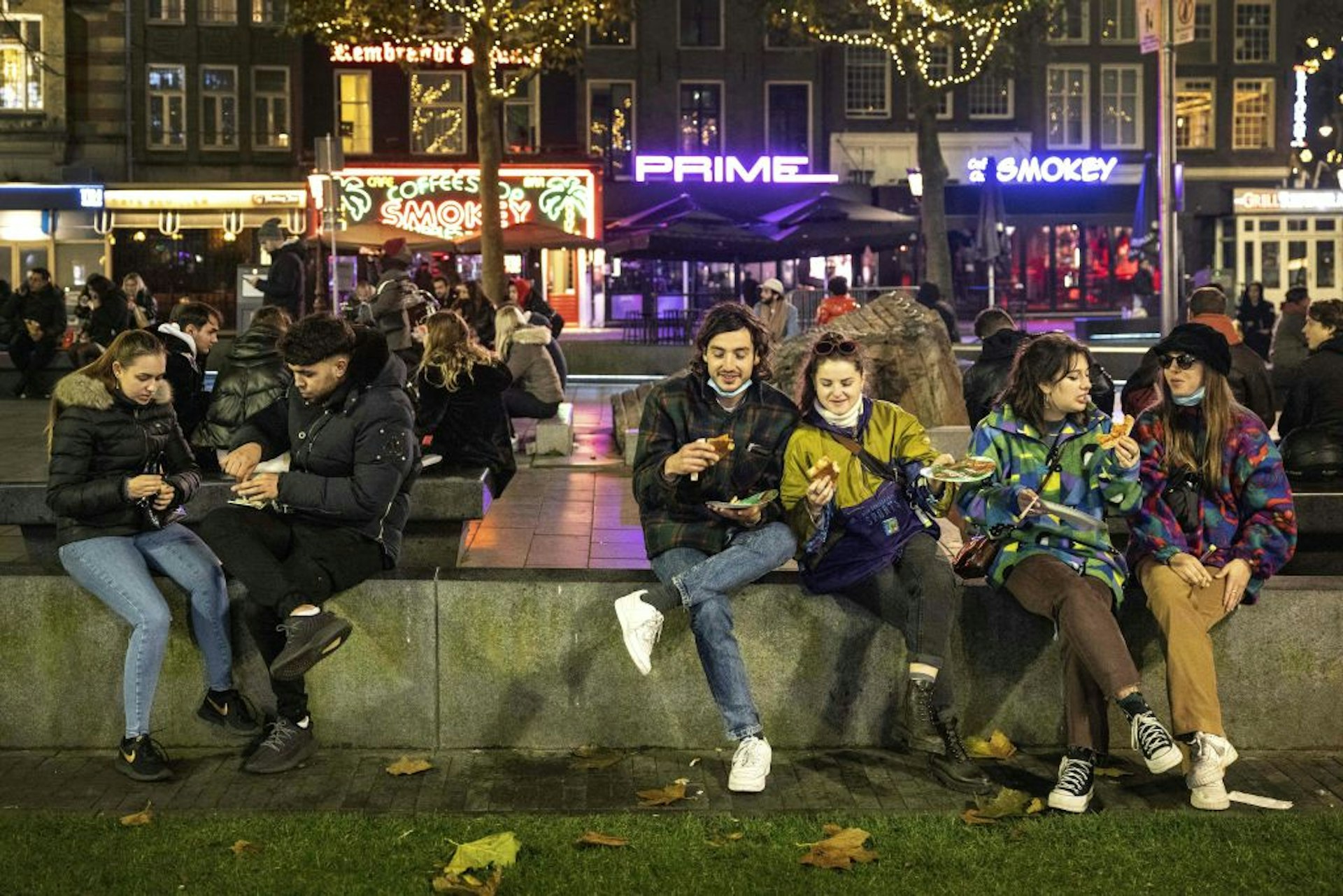 People sitting in Rembrandtplein square in Amsterdam