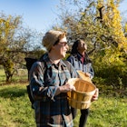 Two female friends of different ethnicities spend an autumn day on the organic Stone Ridge Orchard farm in upstate New York.