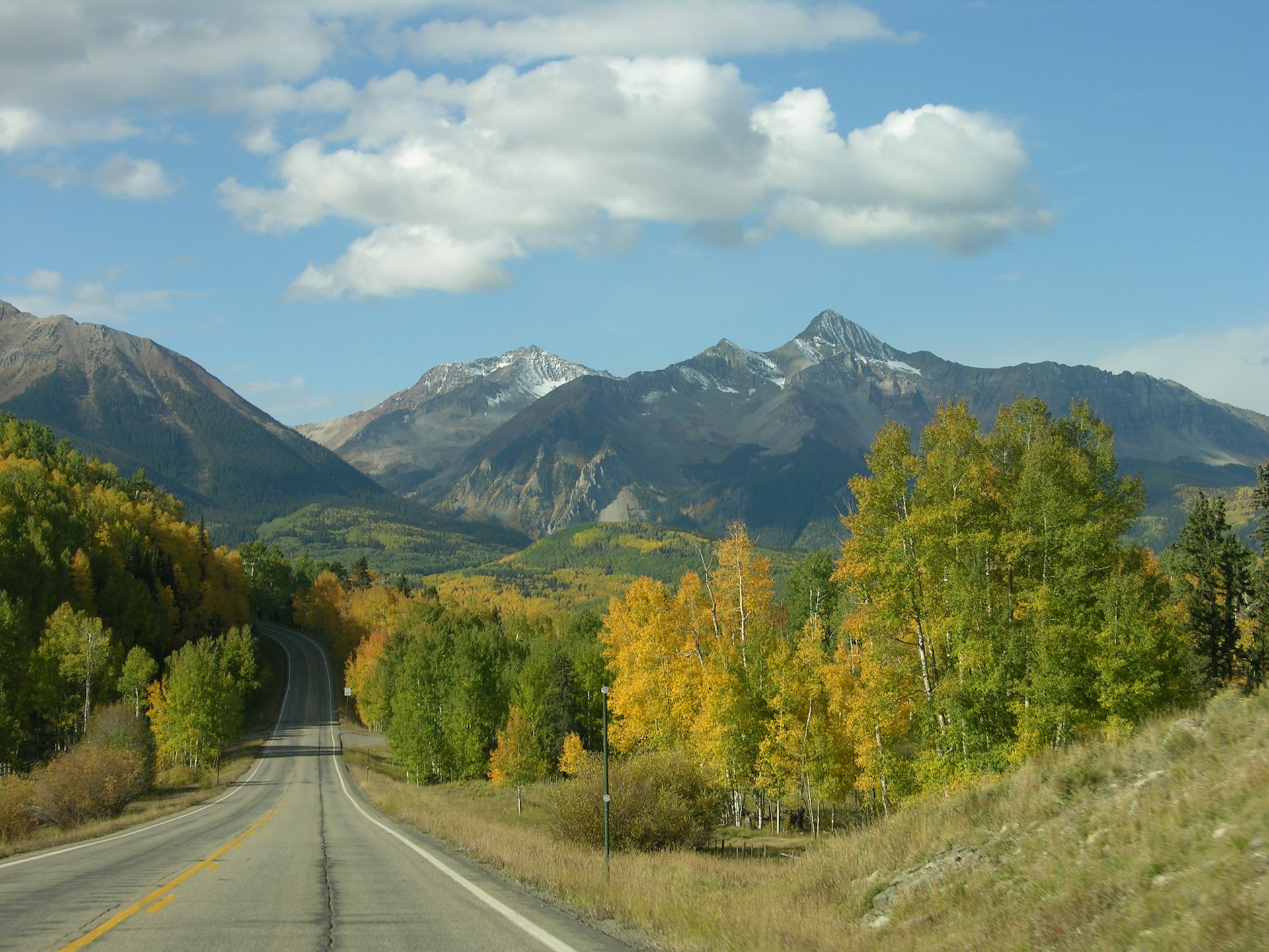 Colorado road in autumn with mountains in the background
