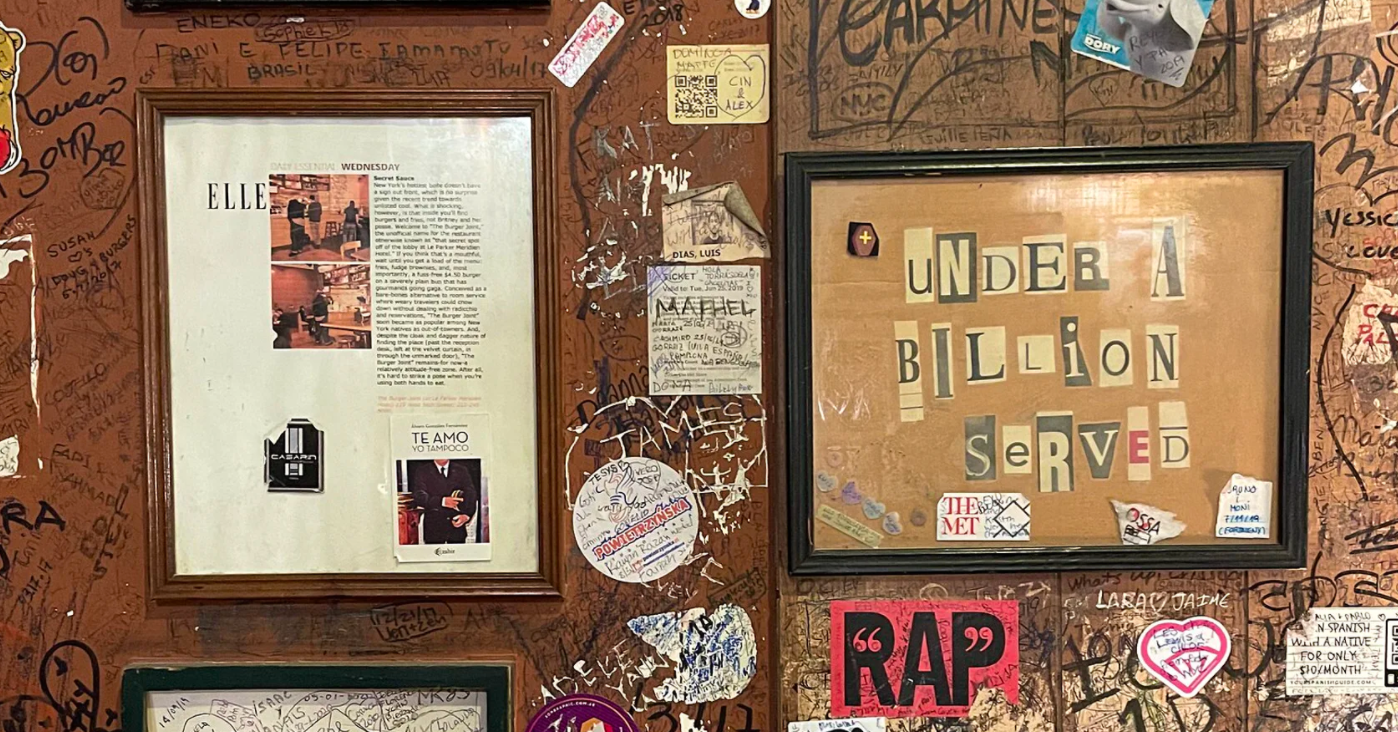 Burger Joint walls with graffiti and framed articles.png