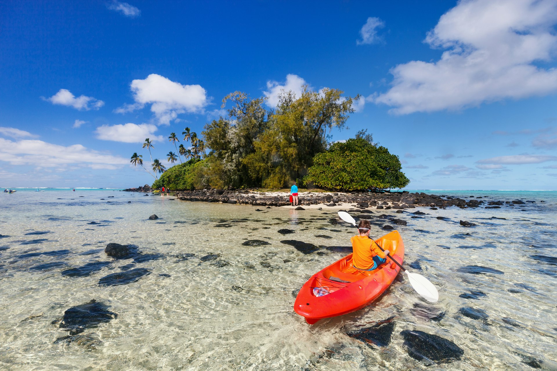 Teenage boy on a kayak in the lagoon in the Cook Islands