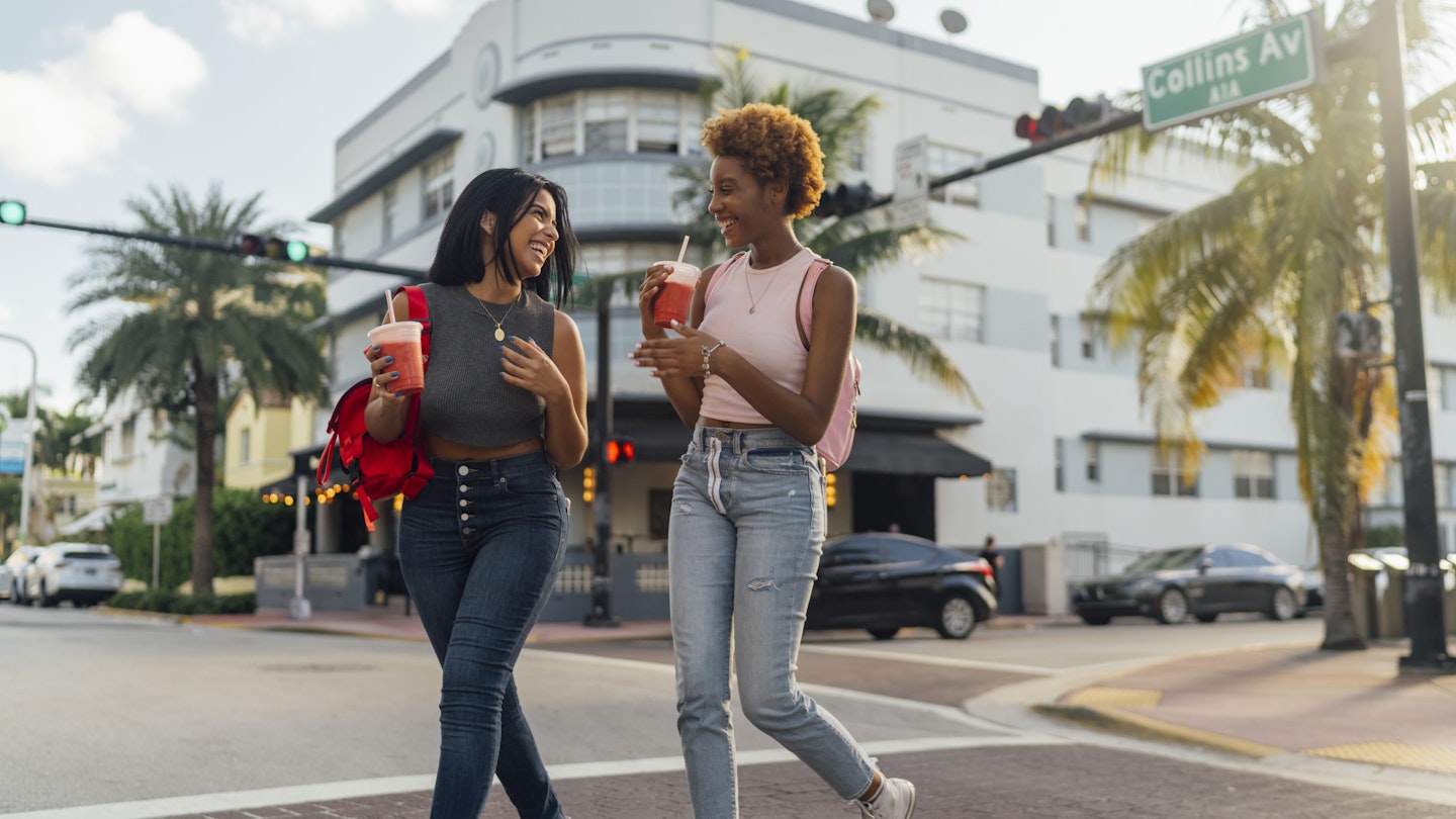 Two female friends walking in Miami Beach