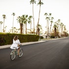 USA, California, Palm Springs, woman riding bicycle on the street