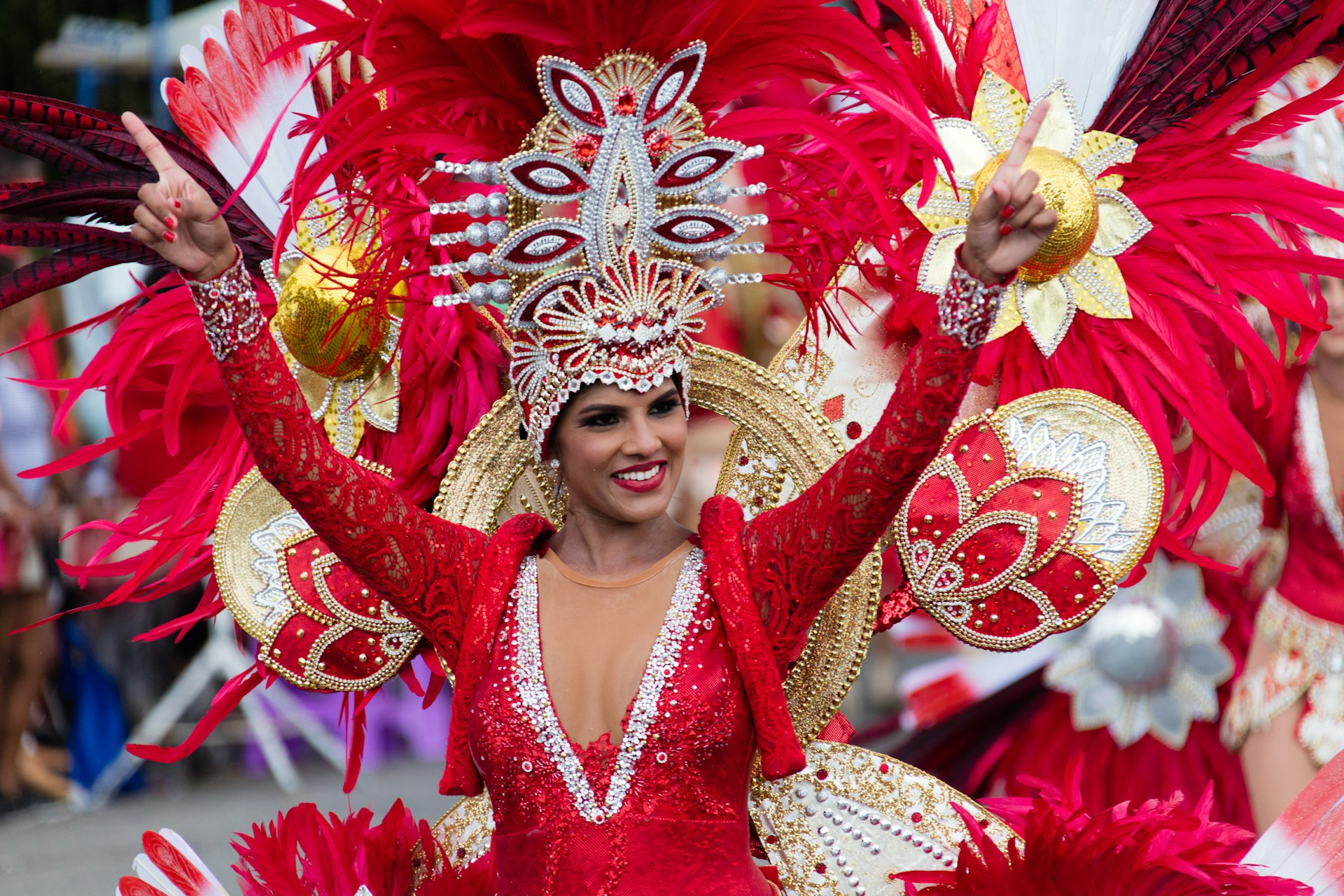 A women in a red costume performs in the carnival of Aruba in Oranjestad