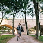 Young woman riding a bicycle in Valencia and exploring the city