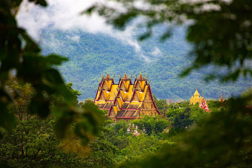 Vue panoramique de Sangkhlaburi - Temple Wat Wang Wiwekaram (et Jedi Buddhakaya en arrière-plan) dans la vallée de la forêt tropicale humide et des nuages ​​bas à Sangkhlaburi.