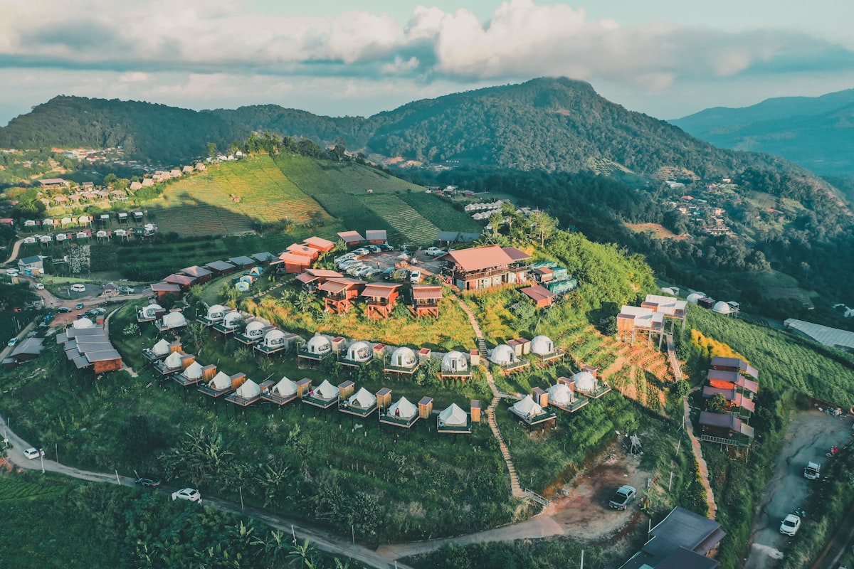 Aerial view of camping grounds and tents on Doi Mon Cham mountain in Mae Rim, Chiang Mai province, Thailand.