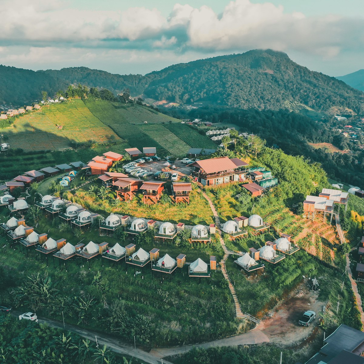 Aerial view of camping grounds and tents on Doi Mon Cham mountain in Mae Rim, Chiang Mai province, Thailand.
