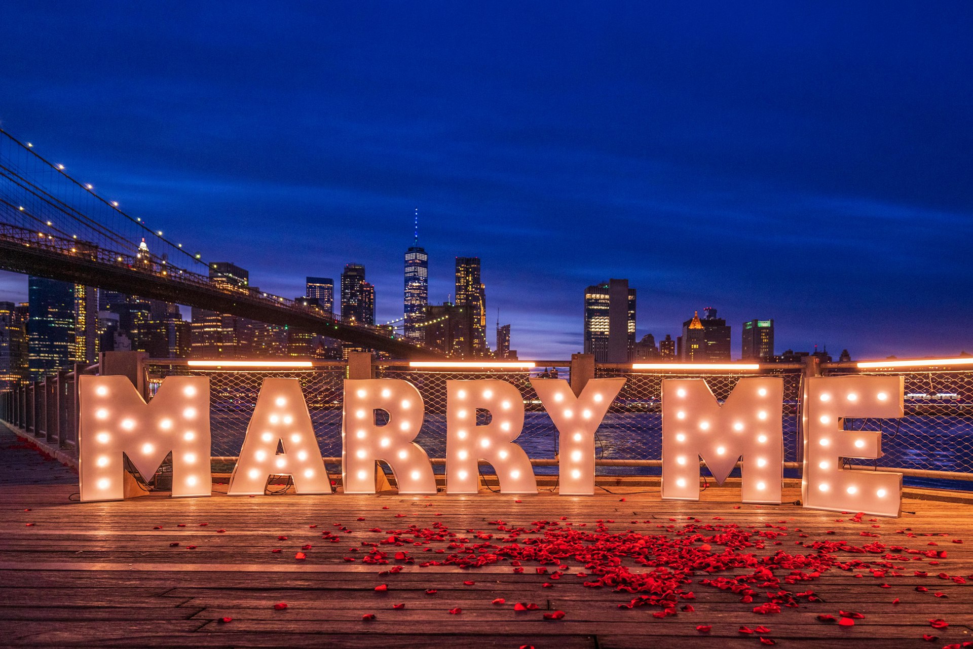 The phrase "Marry Me" lit up in Brooklyn Bridge Park, Brooklyn, NY