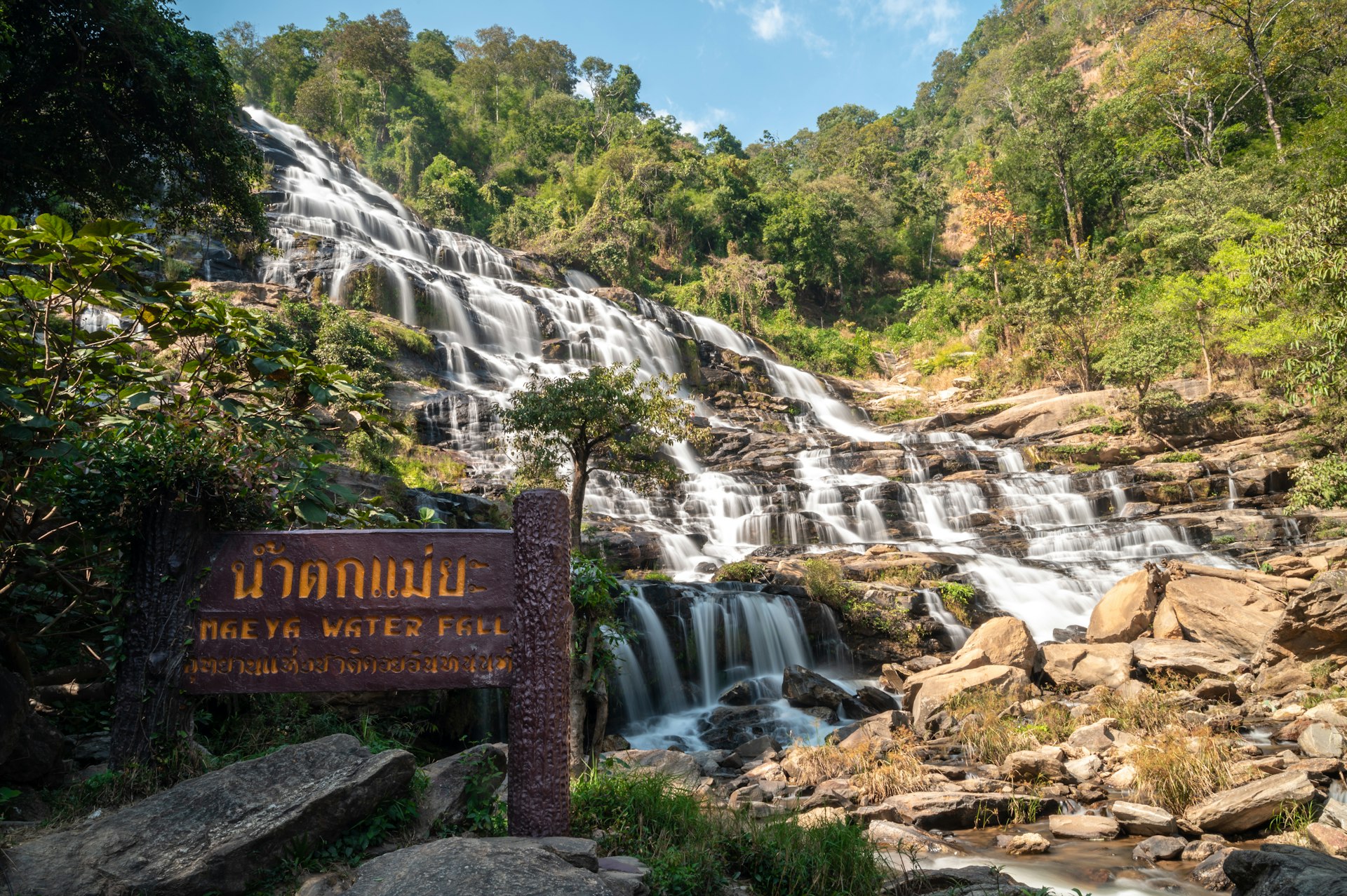 Beautiful view of Mae Ya waterfall with a wooden sign tell the name of this place.