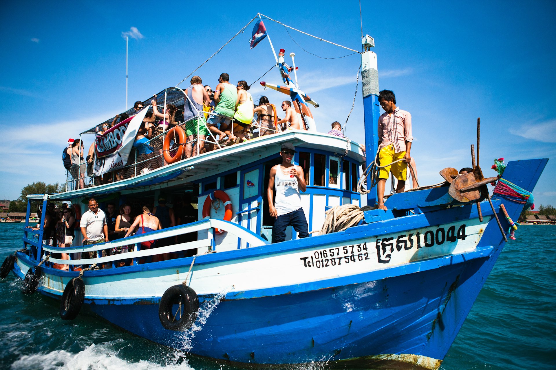 A party cruise takes backpackers out to swim and party in Koh Rong, Cambodia