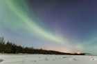The Northern Lights In The Sky Above The Tony Knowles Coastal Trail And Point Woronzof In Winter At Nighttime - stock photo Anchorage Alaska United States Of America