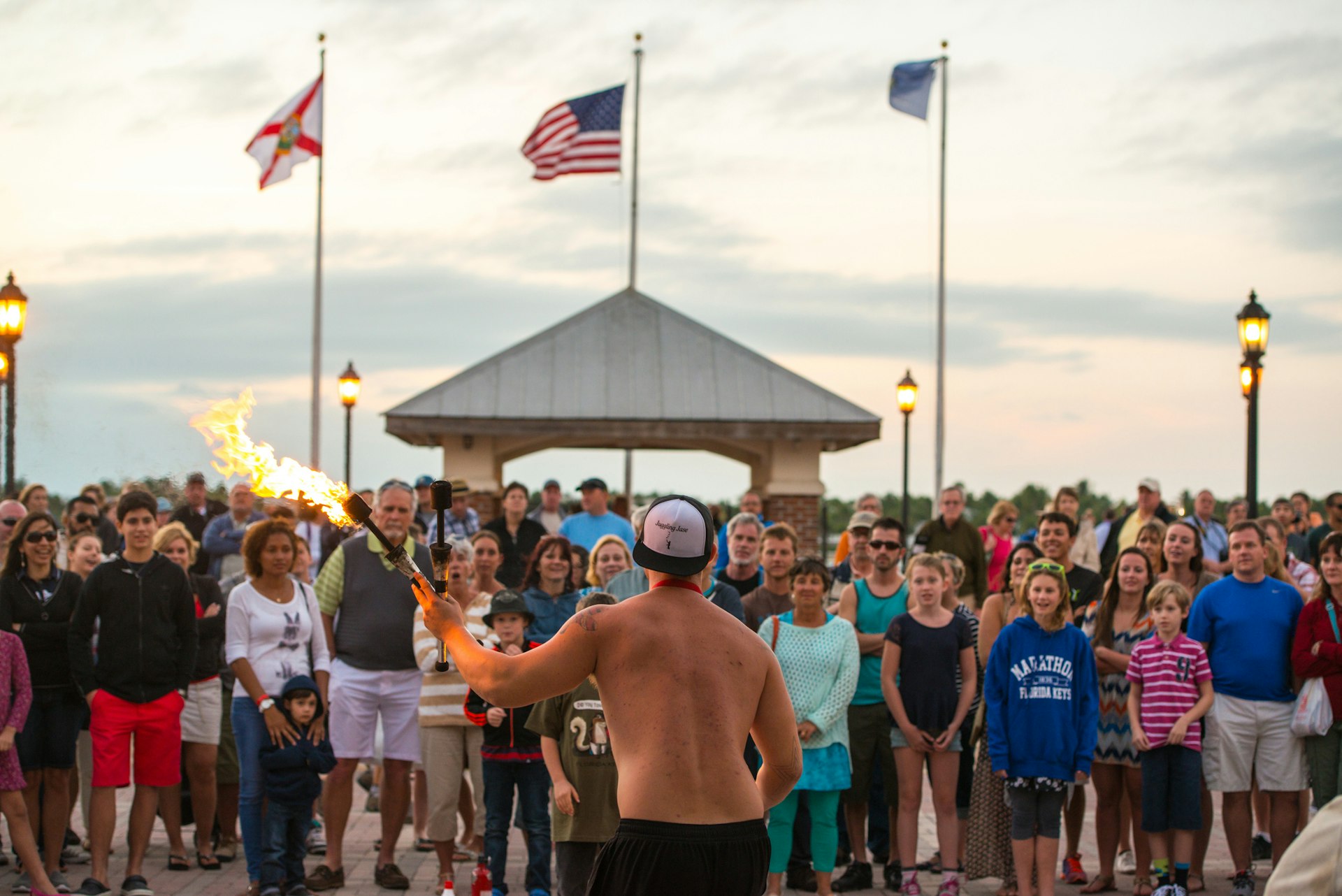 People watching street performer playing with fire, Key West