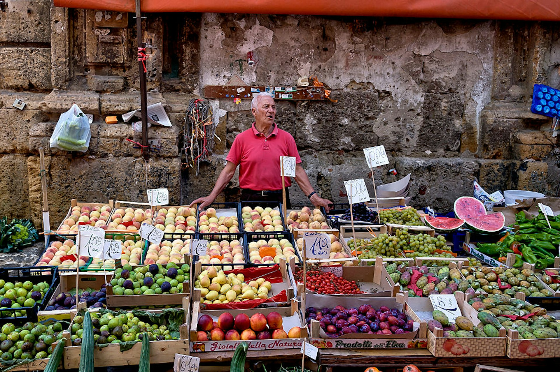 Man selling fruit and vegetables at Ballaro Market in Palermo