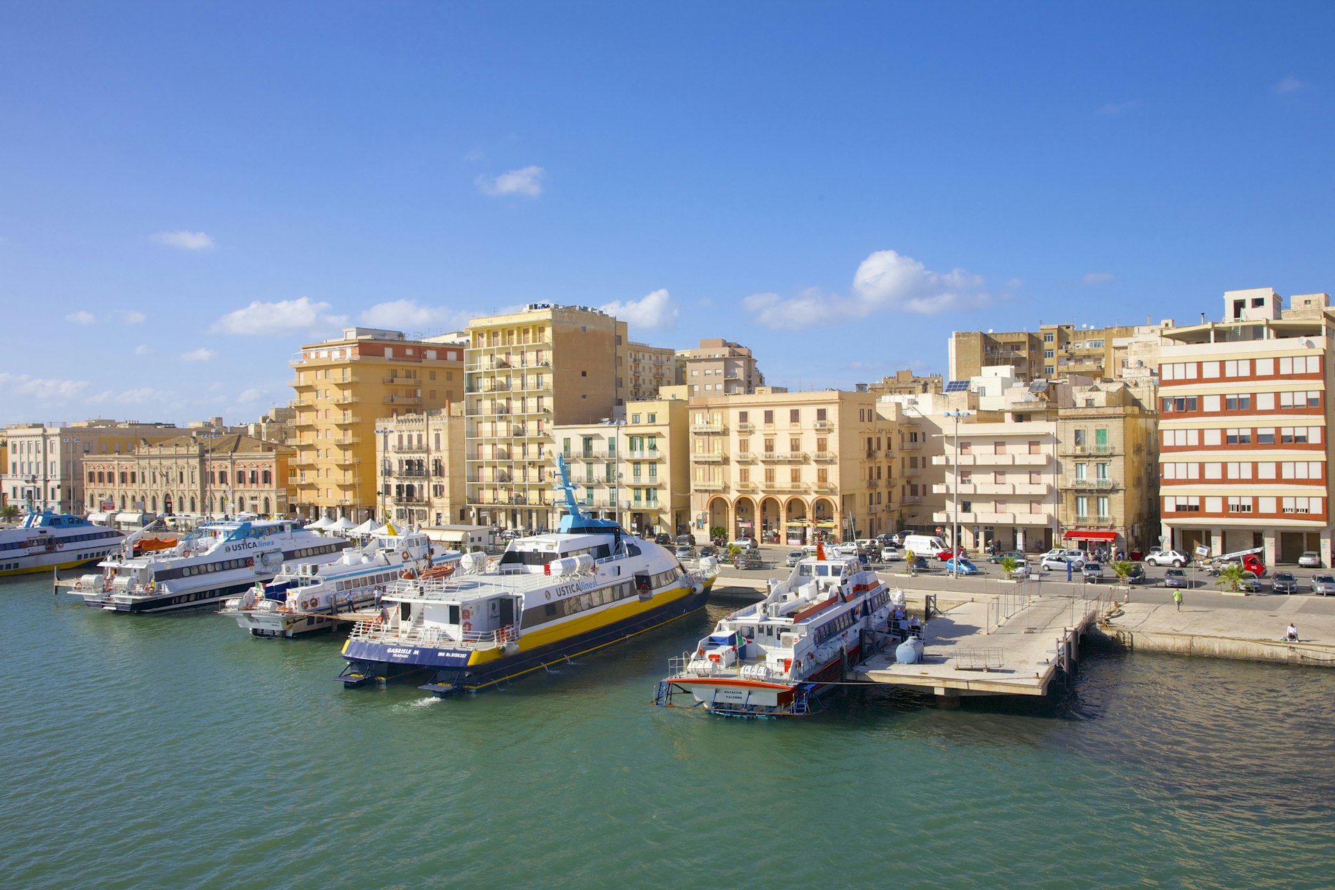 Quaint harbor with boats and ferries docked in a row 