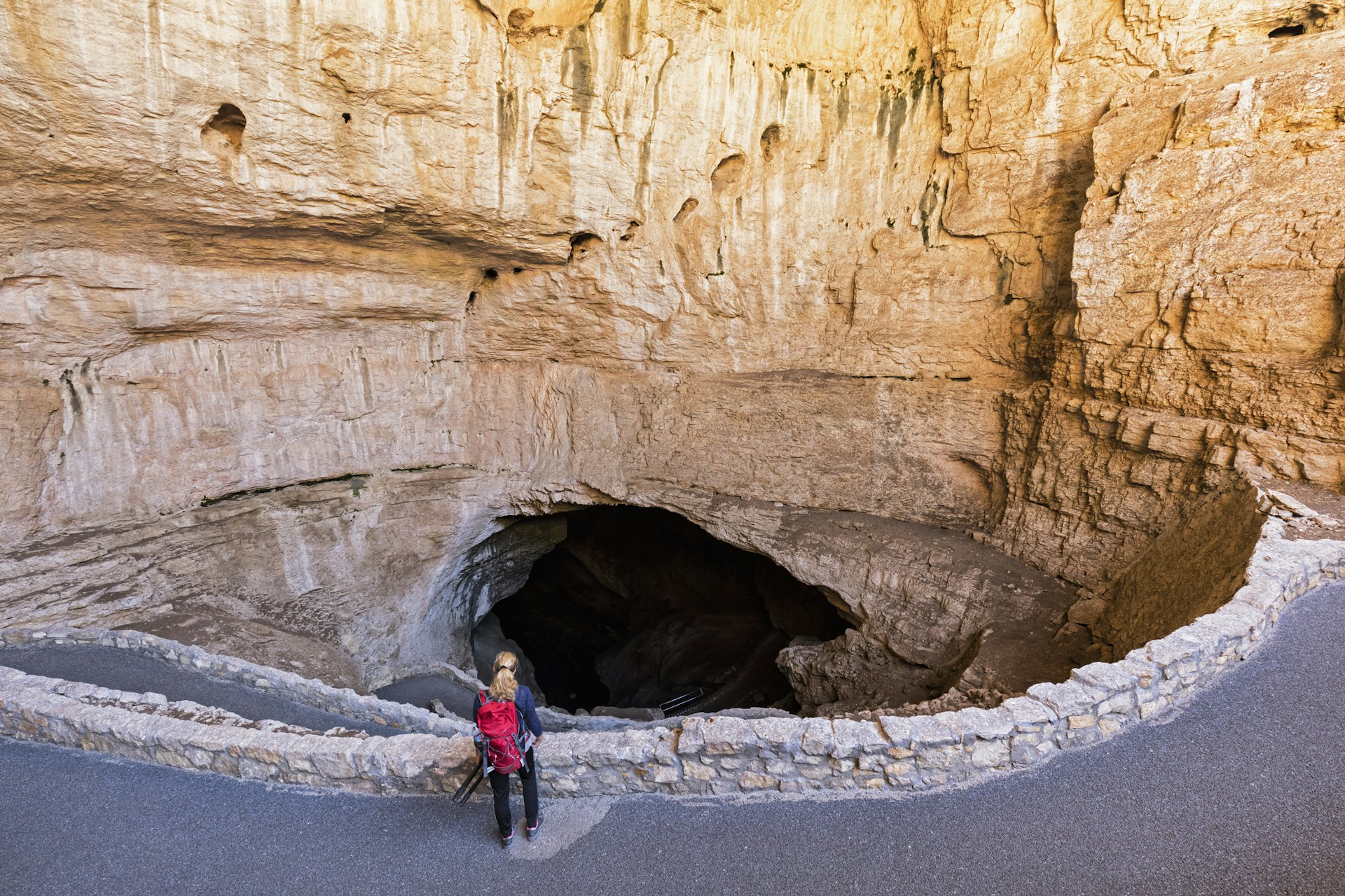 A female tourist stands at the entrance to a cave at Carlsbad Caverns National Park, New Mexico, USA
