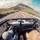 Rear view of a couple driving in a convertible, Lahaina, Maui, Hawaii, America, USA