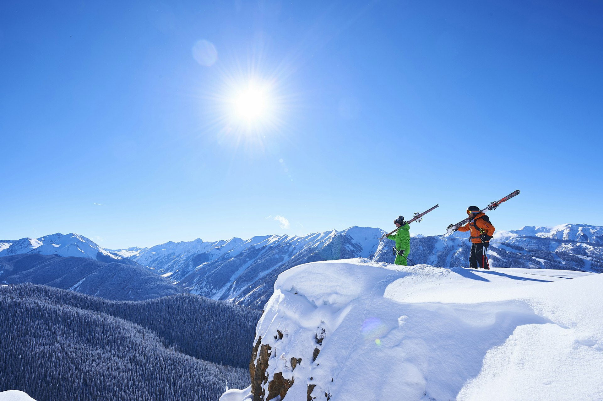 Two skiers take in the snowy views of Aspen, Colorado 