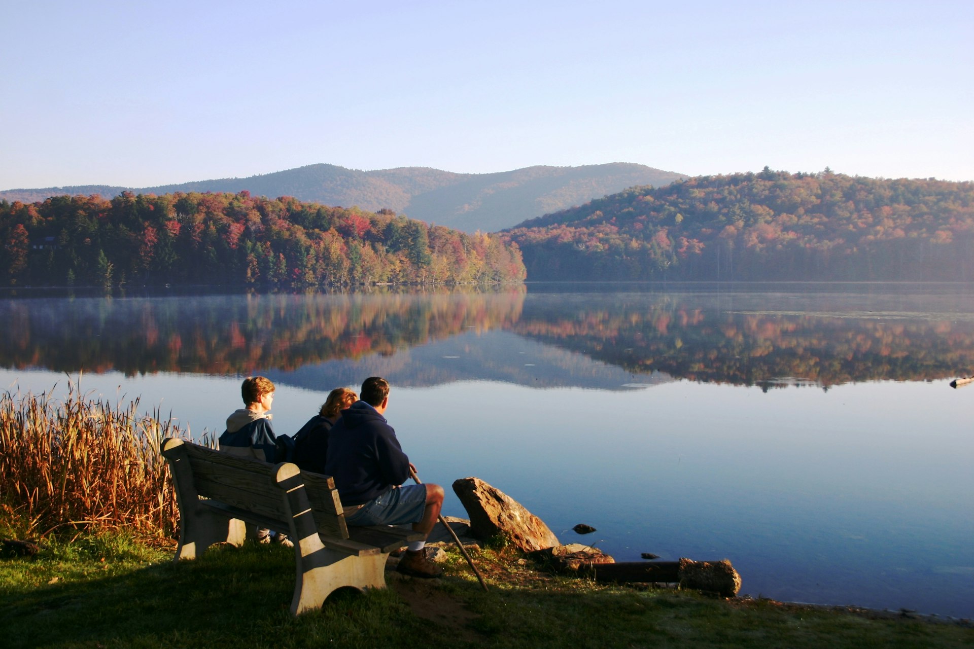 People resting on a bench after a hike in Vermont