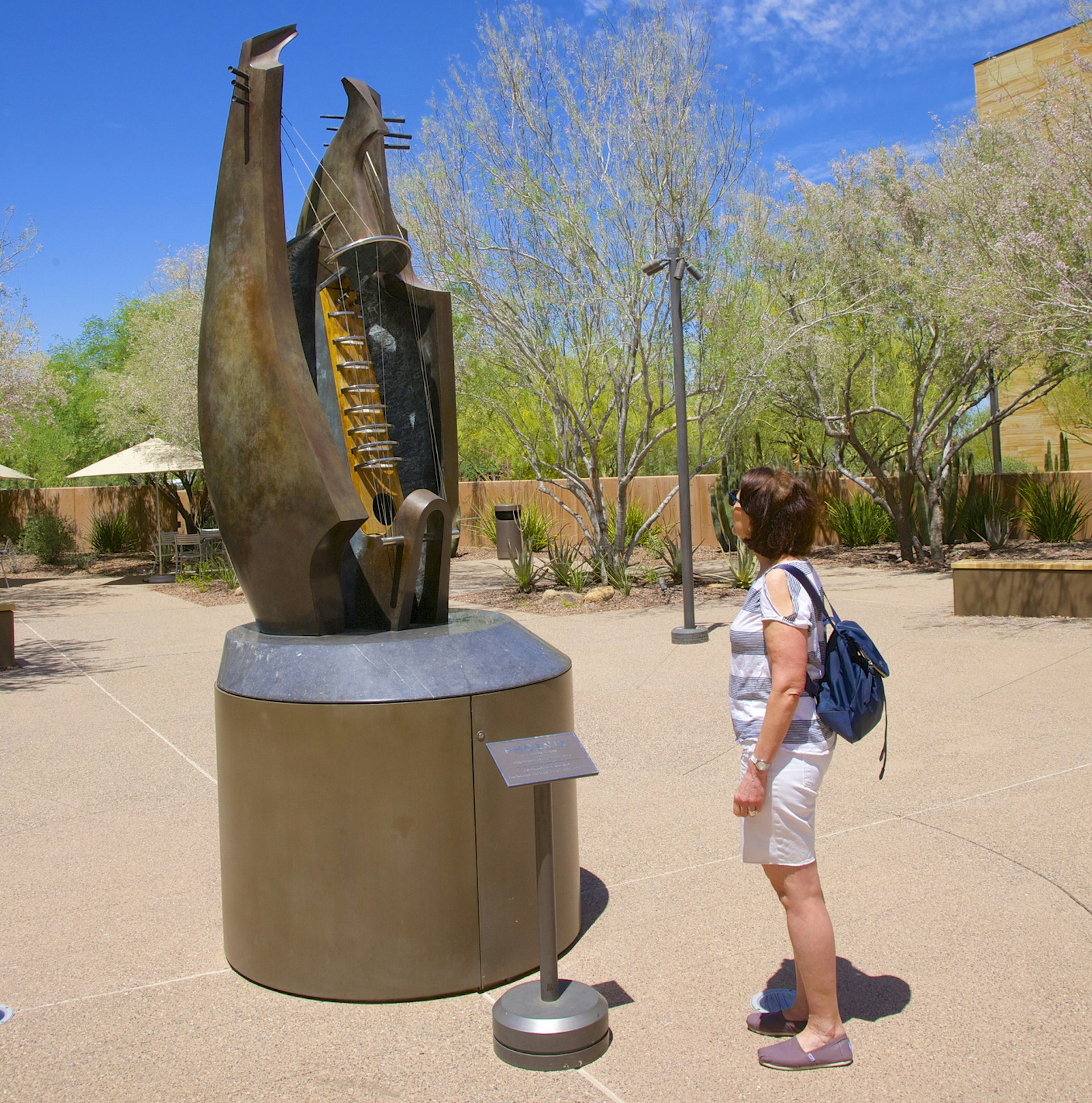 Woman looking at abstract sculpture of musical instrument at Musical Instrument Museum in Phoenix